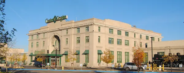 Casino Regina dans l'ancienne Union Station, un bâtiment de pierre pâle à l'entrée en arche, avec des auvents verts et l'enseigne Casino Regina sur le toit, par une journée d'automne ensoleillée